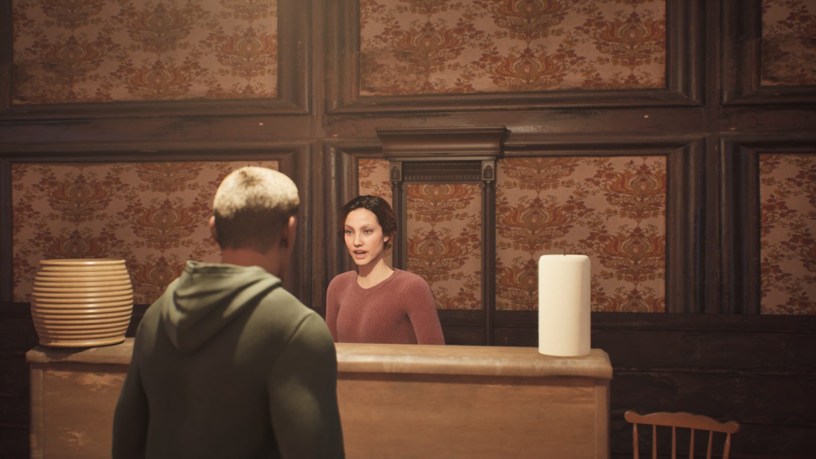 Mrs. Vale behind the reception counter, interviewing the new keeper